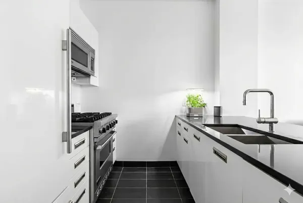 a kitchen with stainless steel appliances a sink stove and cabinets