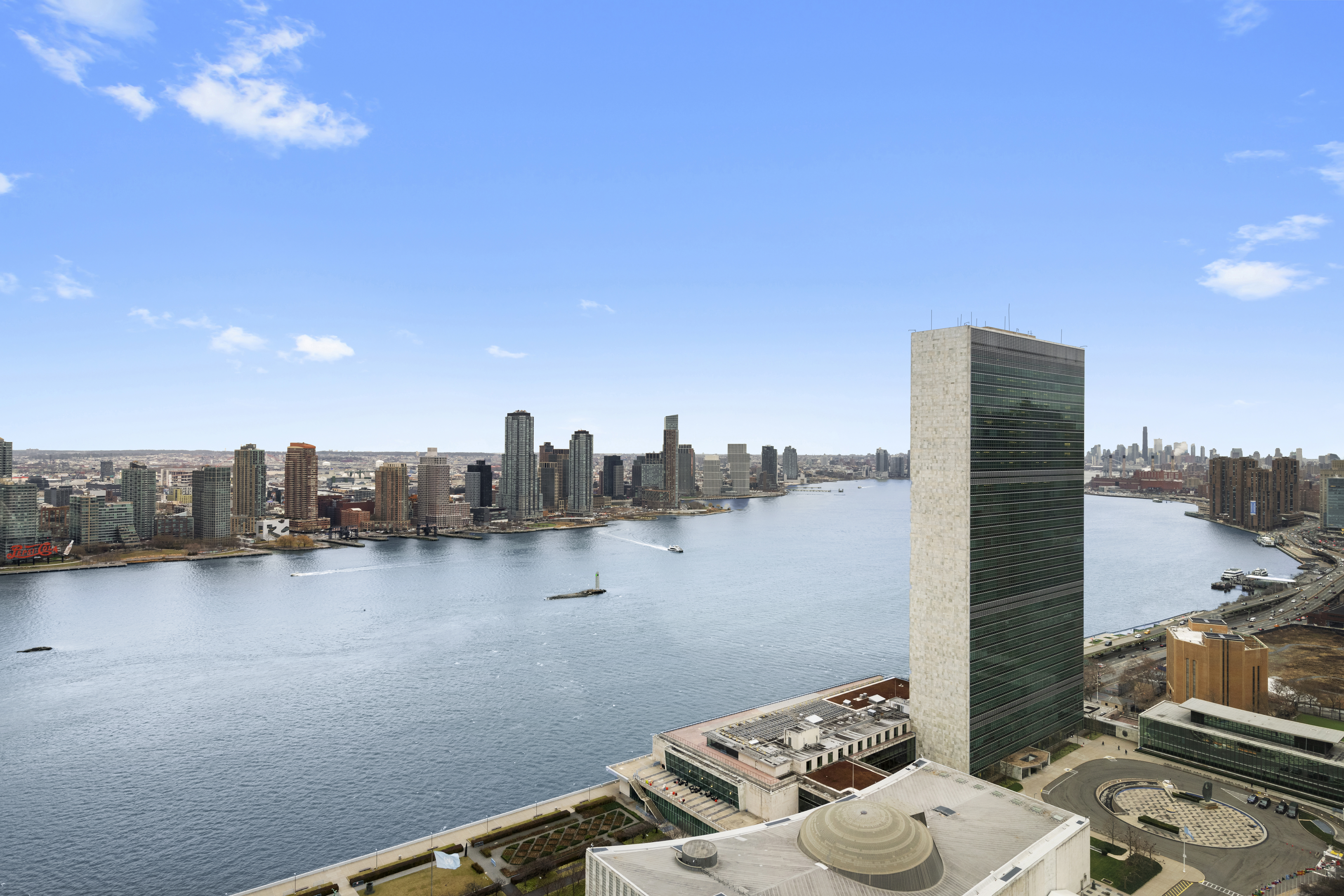 50 United Nations Plaza, Unit 34B Manhattan, NY 10017 - Photo 15 of 17 a view of a terrace with wooden floor and a ocean view