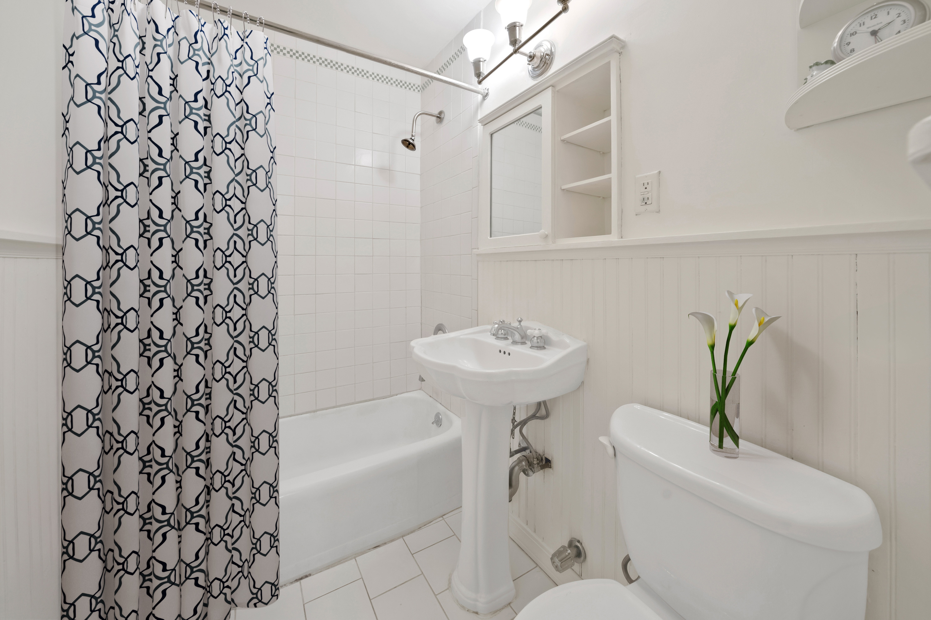 345 East 52nd Street, Unit 8G Manhattan, NY 10022 - Photo 5 of 9 a bathroom with a sink toilet and bathtub