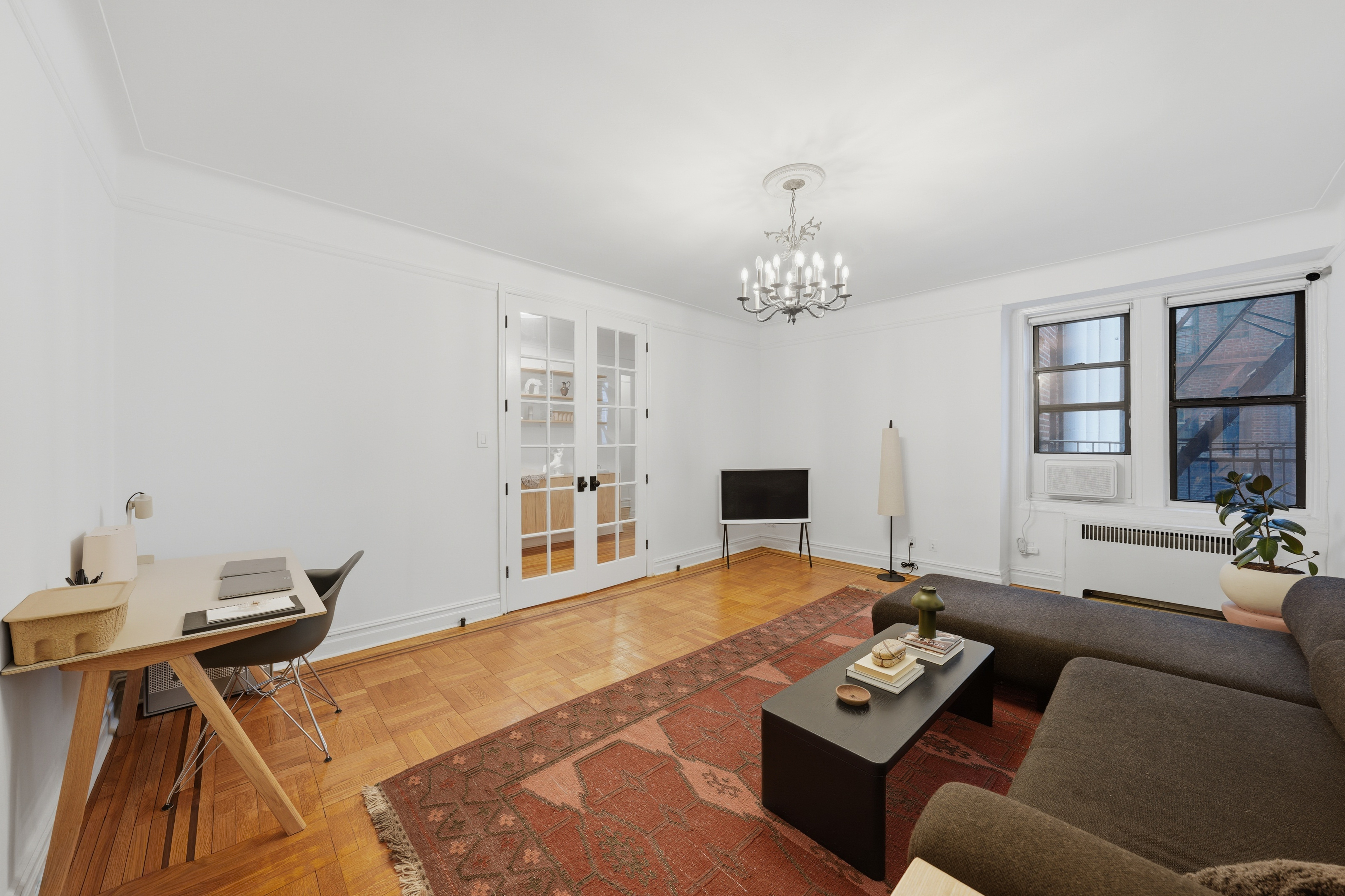 80 Avenue P, Unit D14 Brooklyn, NY 11204 - Photo 4 of 19 a living room with furniture and a chandelier