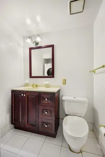 a bathroom with a toilet a sink and mirror