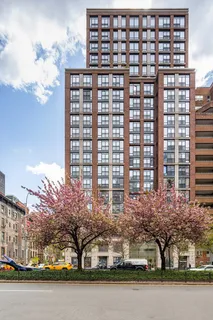 a front view of a building with lake view and trees