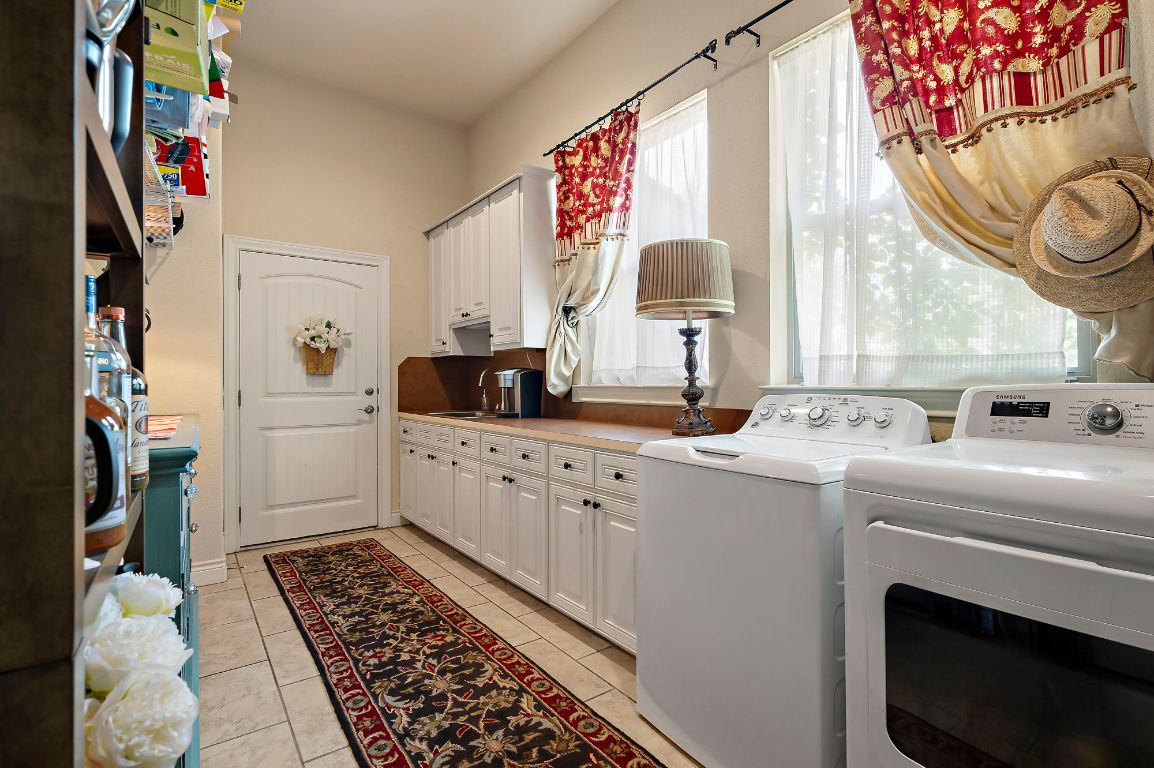1607 The High Road Austin, TX 78746 - Photo 12 of 28 a kitchen with a sink stove and cabinets