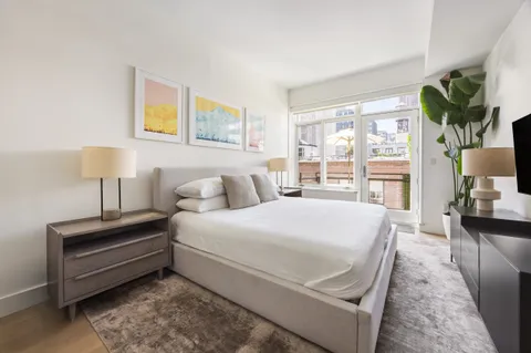 a bed room with a bed and a night stand