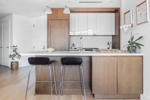 a kitchen with a sink cabinets and window