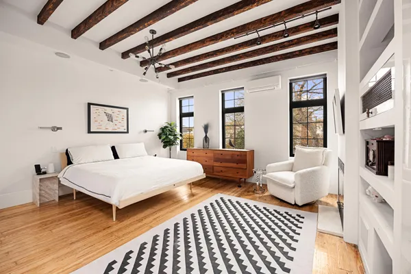 a spacious bedroom with two beds and a couch