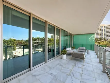 a living room with fireplace furniture and a large window