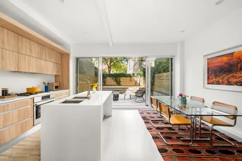 a room with furniture a flat screen tv and a dining table