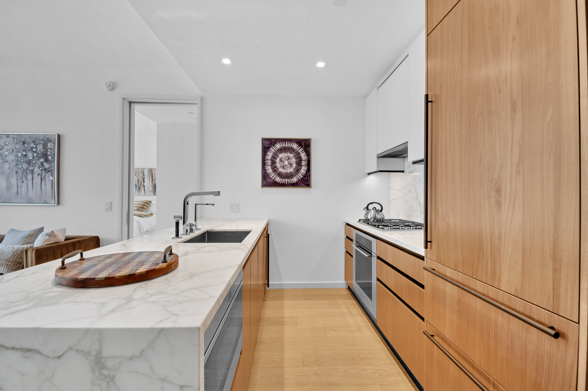 1 West End Avenue, Unit 16L Manhattan, NY 10069 - Photo 8 of 11 a kitchen with stainless steel appliances granite countertop a sink stove and refrigerator