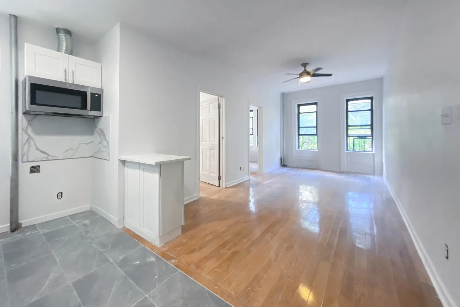 wooden floor in an empty room with a window