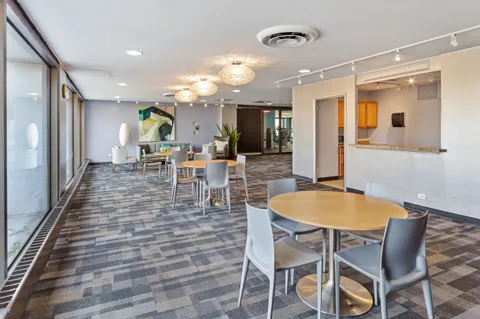 a dining room with furniture and window