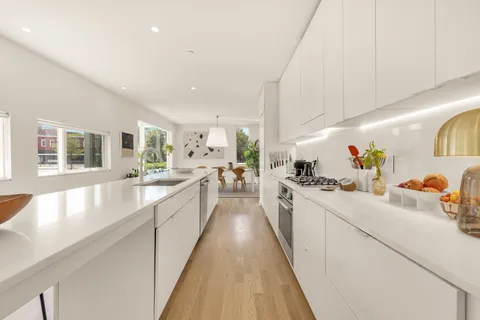 a large white kitchen with lots of counter top space