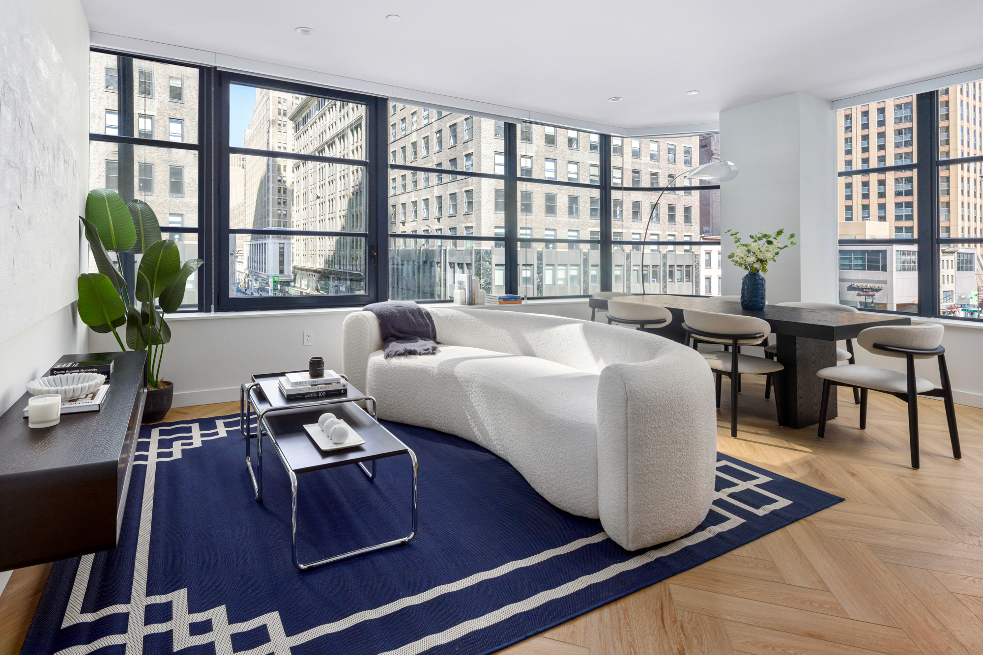 980 6th Avenue, Unit 416 Manhattan, NY 10018 - Photo 3 of 22 a living room with furniture and a large window