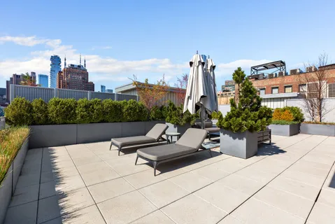 a swimming pool with outdoor seating and plants