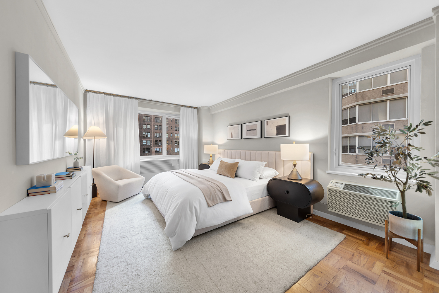 411 East 53rd Street, Unit 8C Manhattan, NY 10022 - Photo 5 of 10 a spacious bedroom with a bed and a couch