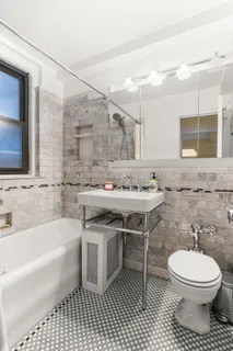 a bathroom with a sink a toilet and bathtub
