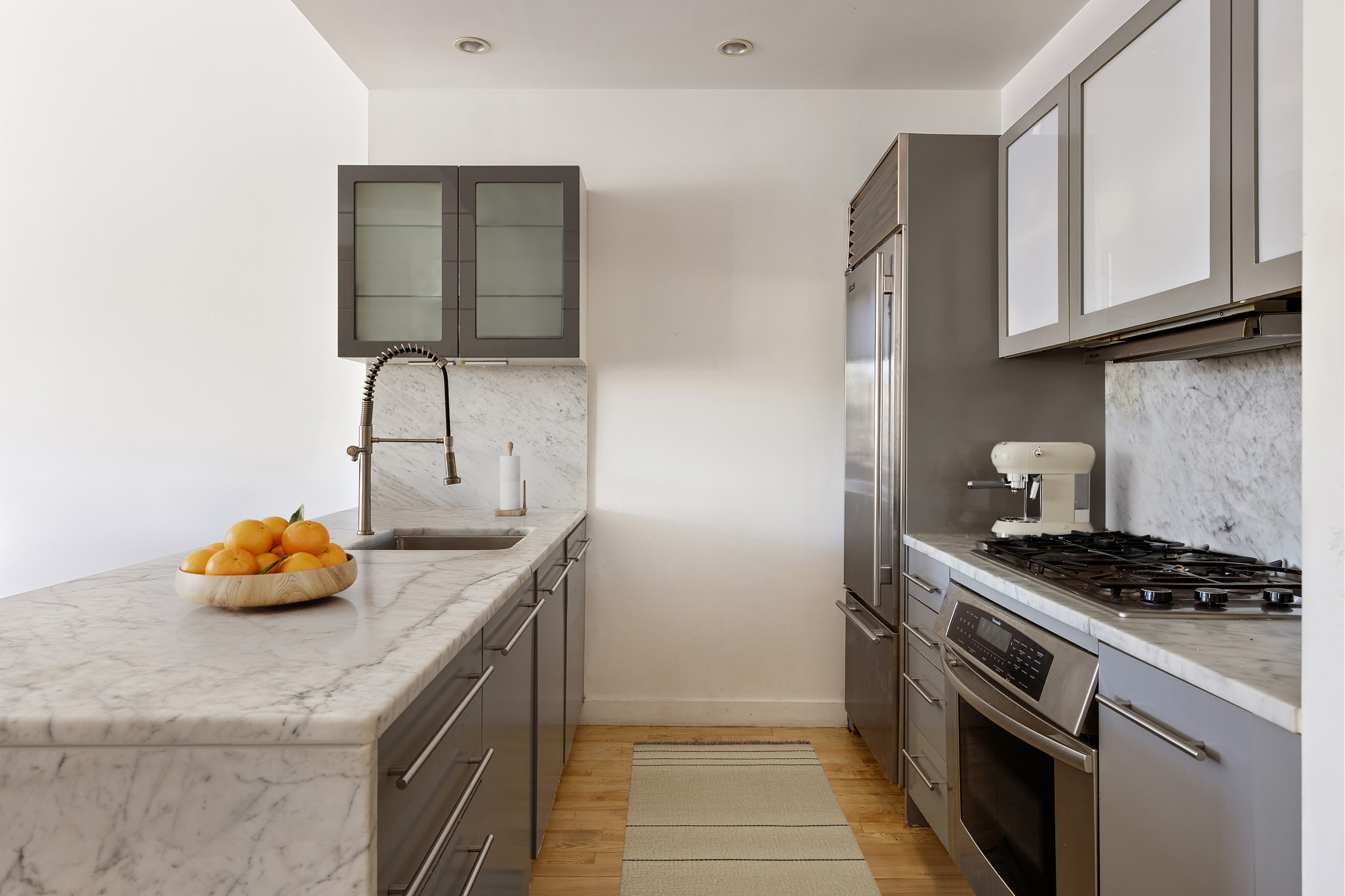 210 Lafayette Street, Unit 2D Manhattan, NY 10012 - Photo 5 of 14 a kitchen with stainless steel appliances granite countertop a sink stove and cabinets