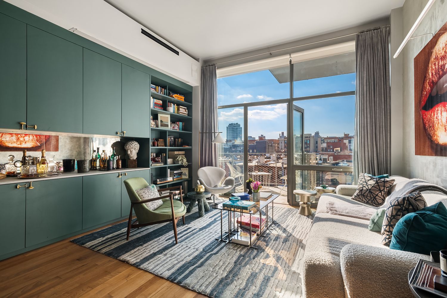 a living room with furniture a flat screen tv and a floor to ceiling window