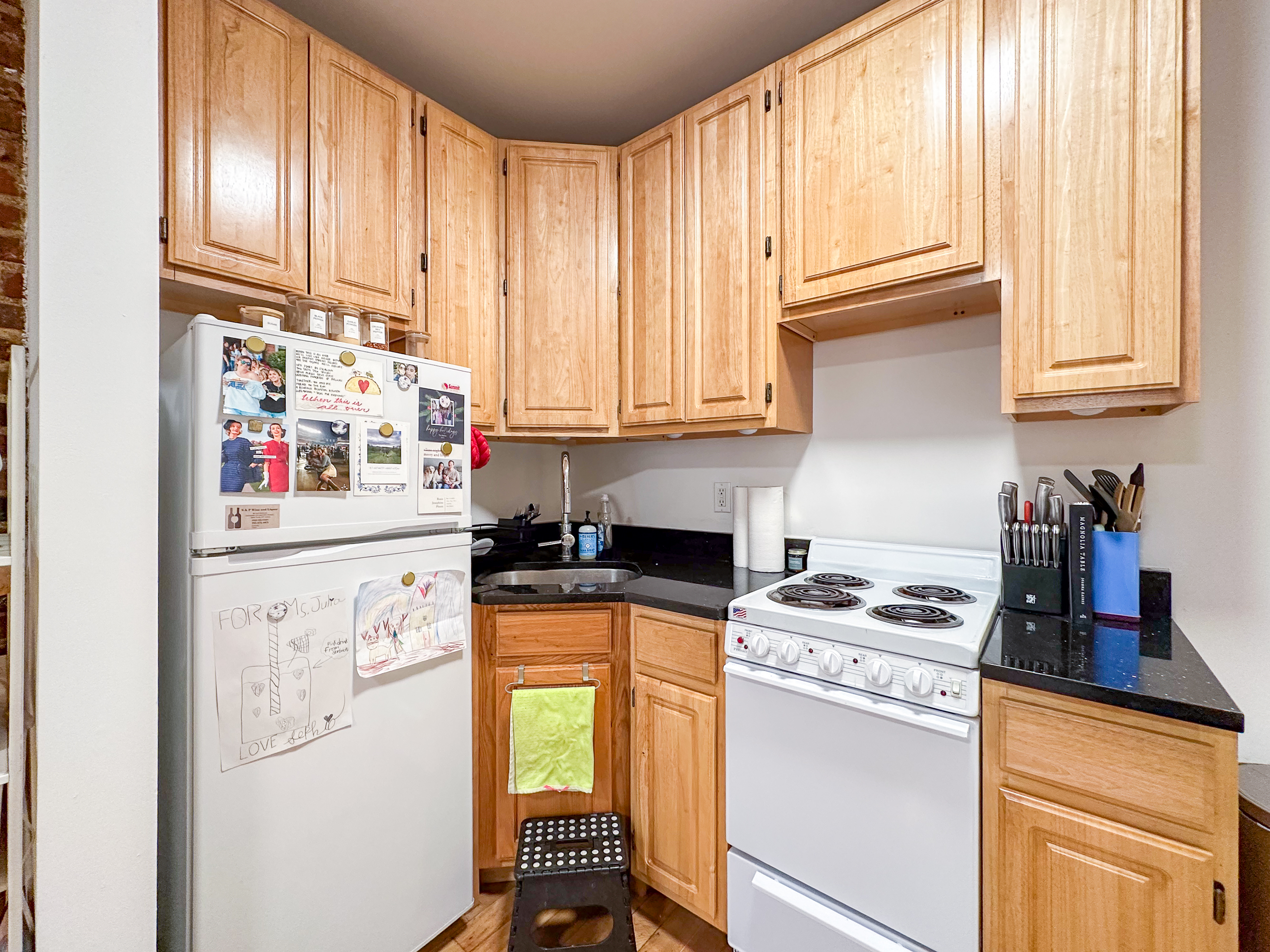 315 East 5th Street, Unit 5E Manhattan, NY 10003 - Photo 5 of 11 a kitchen with stainless steel appliances granite countertop a stove a sink and a refrigerator
