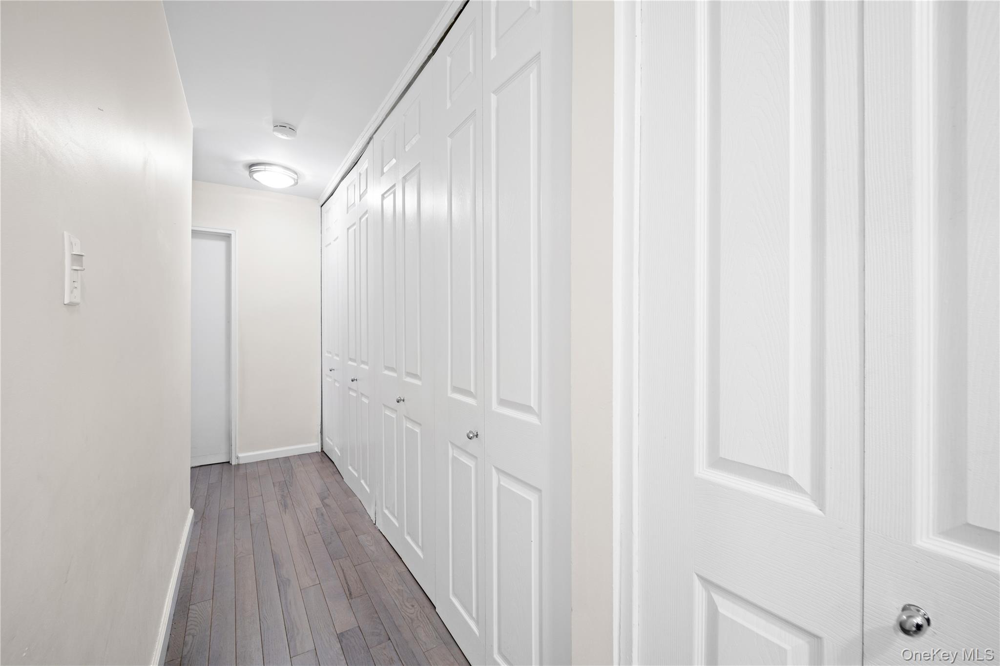 75-34 Bell Boulevard, Unit LD Queens, NY 11364 - Photo 22 of 26 a view of a hallway with wooden floor