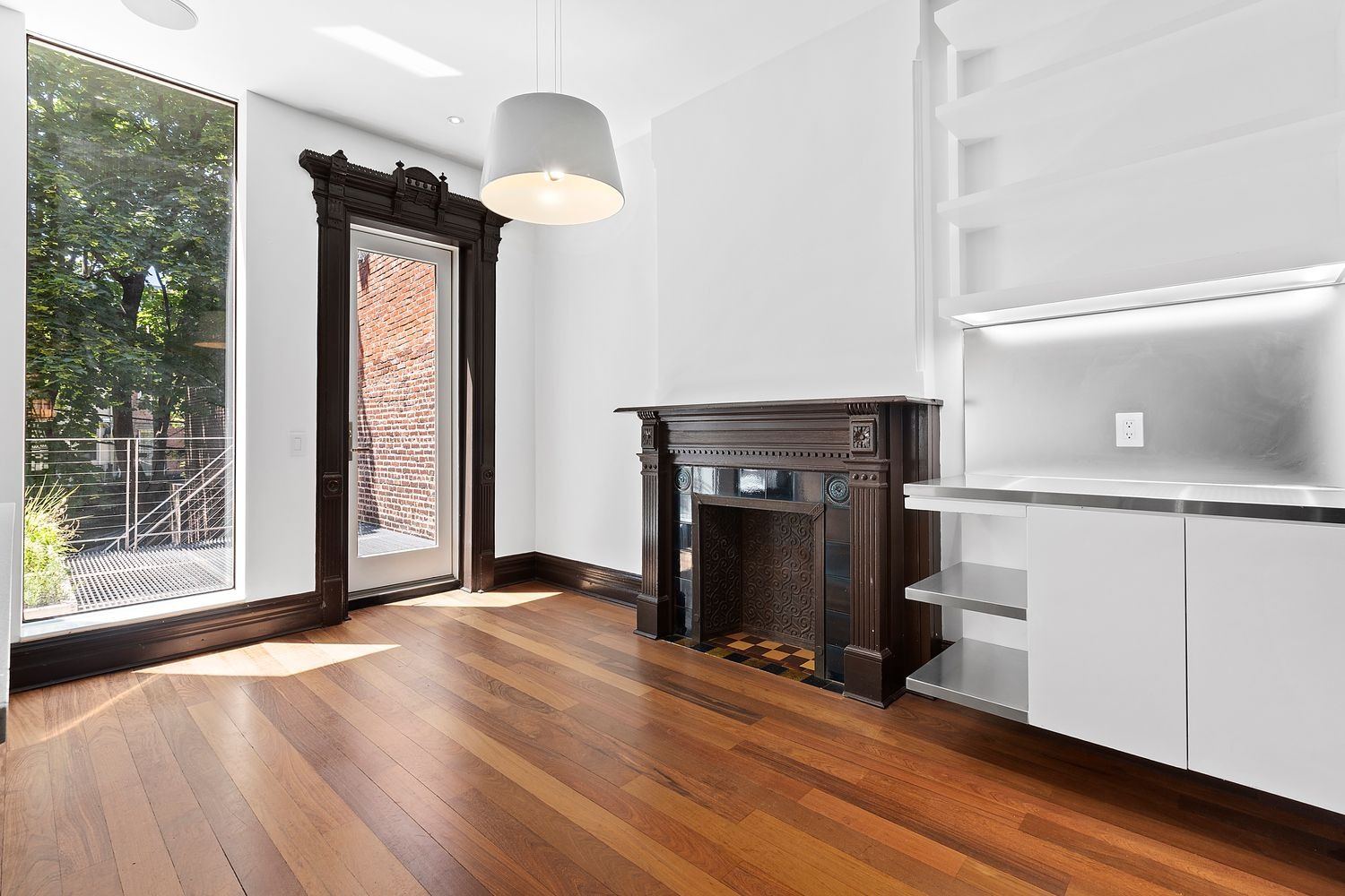 64 Clifton Place, Unit PARLOR Brooklyn, NY 11238 - Photo 8 of 17 a view of an empty room with wooden floor a fireplace and a window