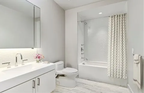 a bathroom with a sink toilet and shower