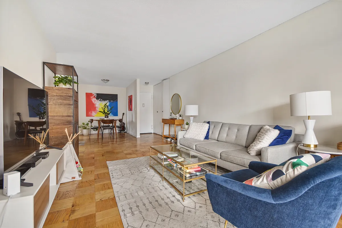 345 East 80th Street, Unit 17J Manhattan, NY 10075 - Photo 2 of 8 a living room with furniture and a flat screen tv