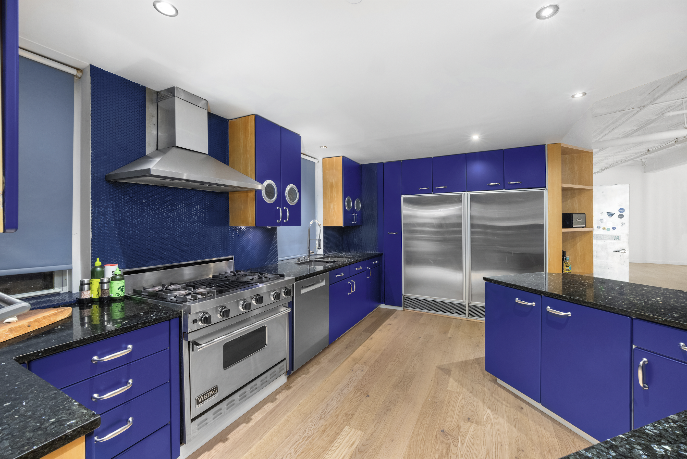 253 West 28th Street, Unit 5 Manhattan, NY 10001 - Photo 18 of 19 a kitchen with stainless steel appliances granite countertop a stove and a refrigerator