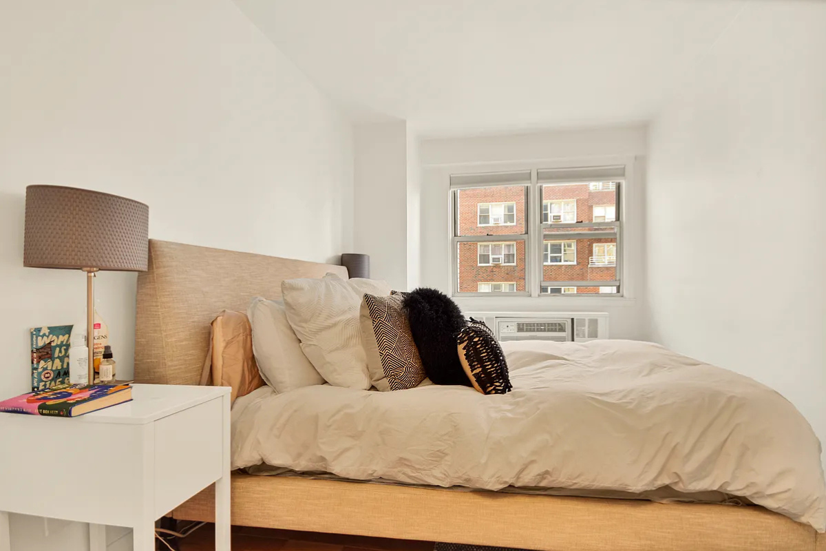 245 East 35th Street, Unit 9D Manhattan, NY 10016 - Photo 2 of 8 a large bed sitting in a bedroom next to a window
