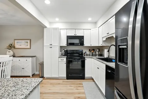 a kitchen with a refrigerator stove and sink