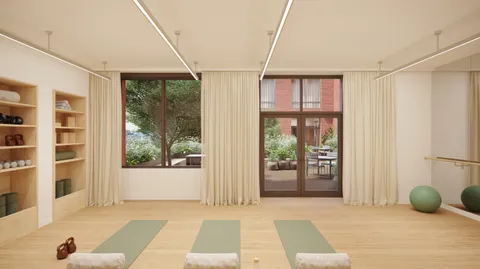 a bedroom with furniture and large windows