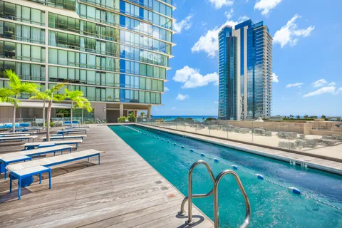 a swimming pool with outdoor seating and yard