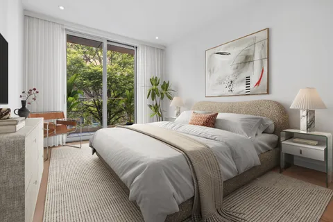 a bedroom with a large bed and a large window