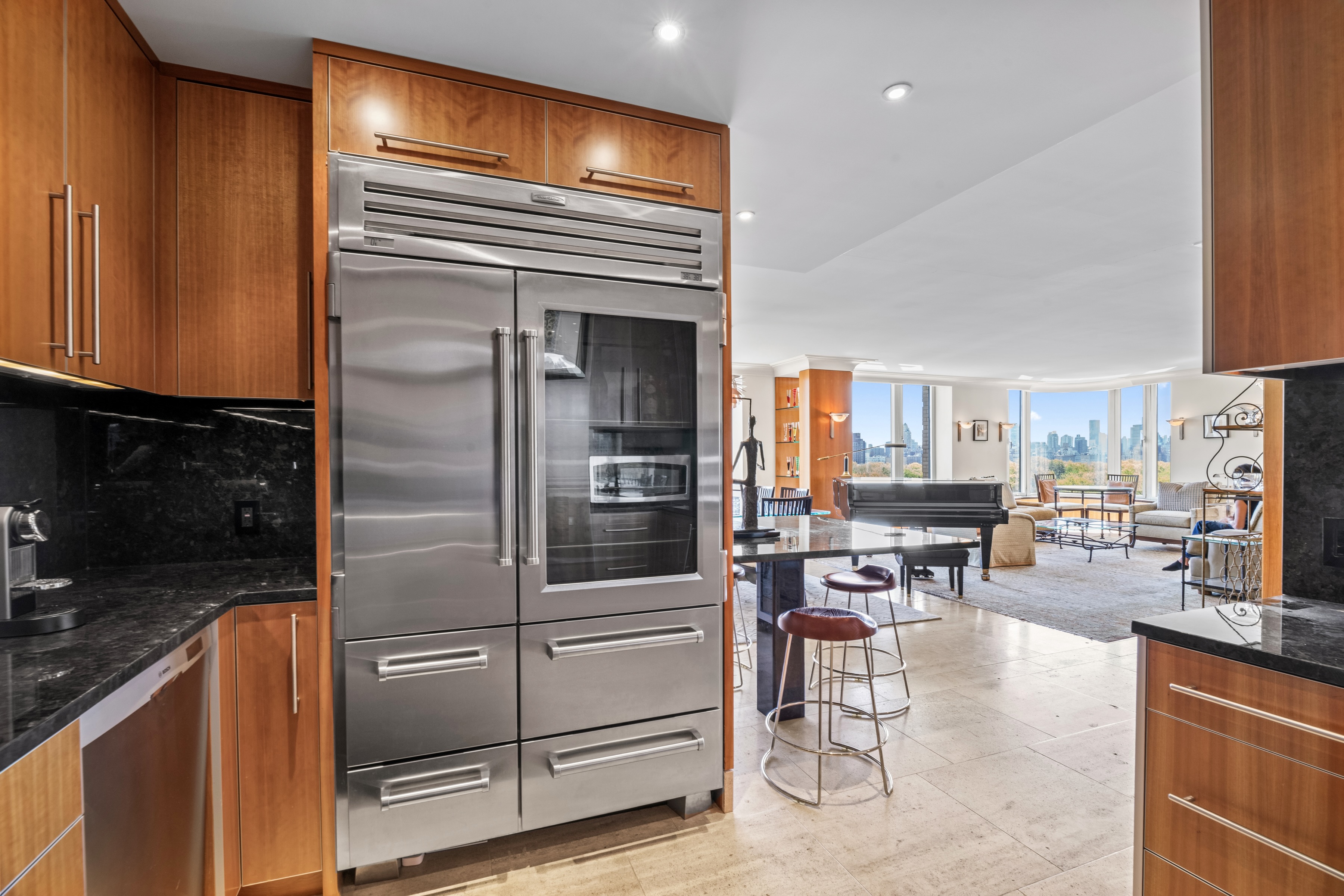 279 Central Park West, Unit 11B Manhattan, NY 10024 - Photo 8 of 24 a kitchen with stainless steel appliances kitchen island granite countertop a refrigerator and cabinets