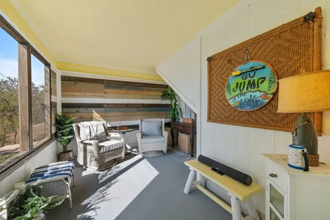 a living room with furniture and kitchen view