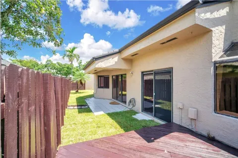 a view of a house with backyard porch and sitting area