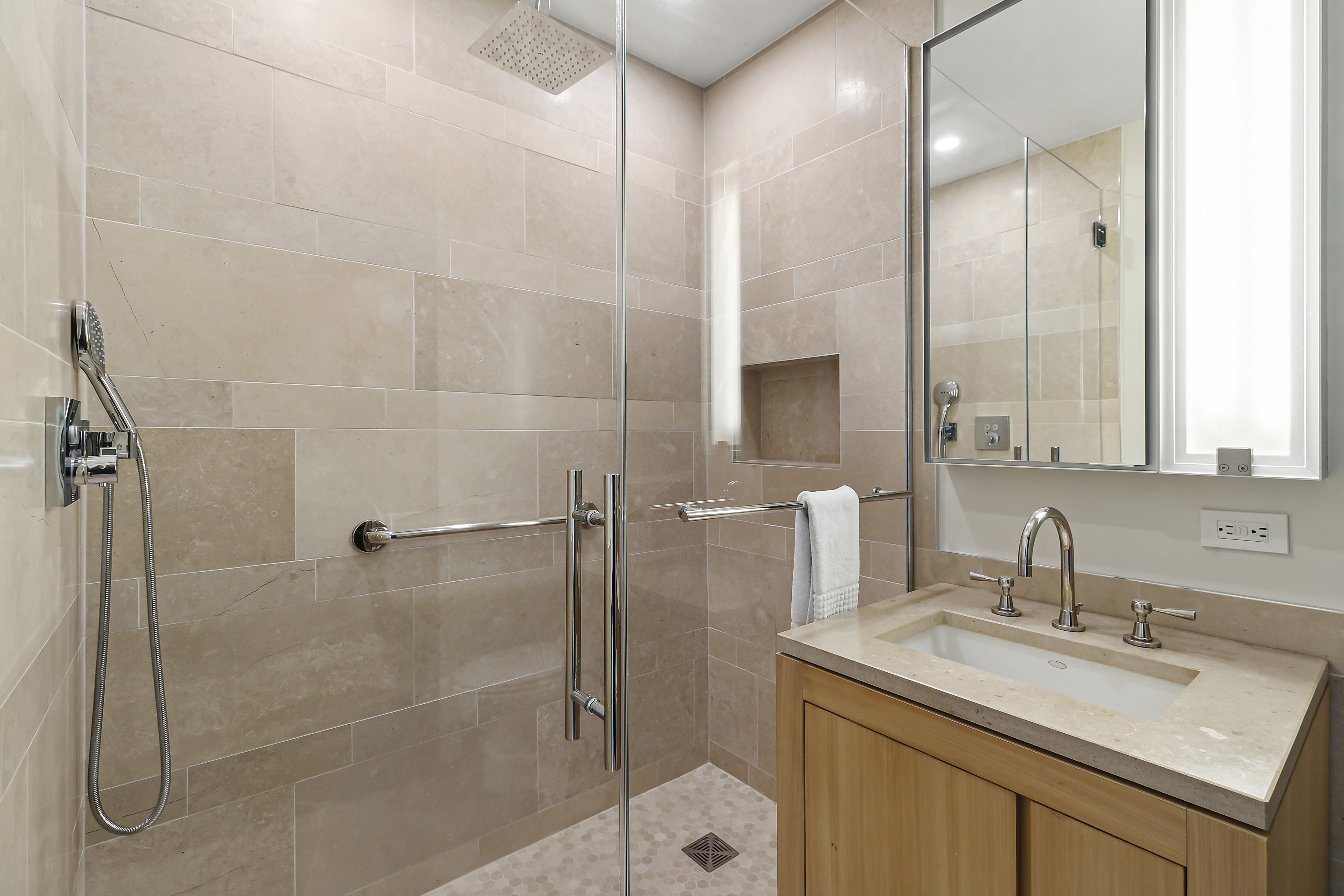 450 East 83rd Street, Unit PH1B Manhattan, NY 10028 - Photo 13 of 15 a bathroom with a granite countertop sink a mirror and shower