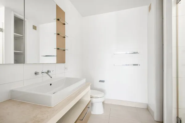 a white toilet sitting next to a bathroom sink