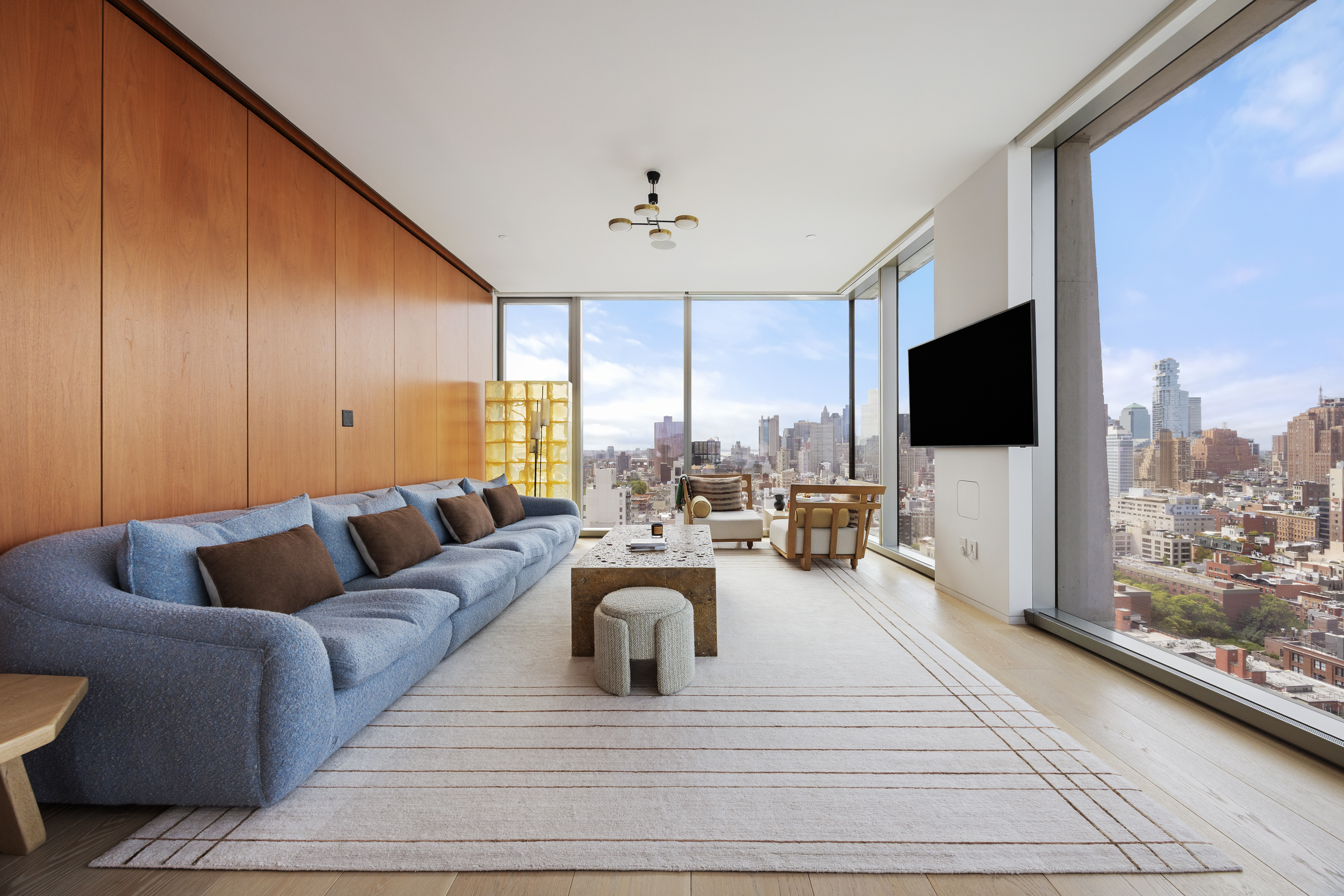 215 Chrystie Street, Unit 29W Manhattan, NY 10002 - Photo 3 of 24 a living room with furniture fireplace and a flat screen tv