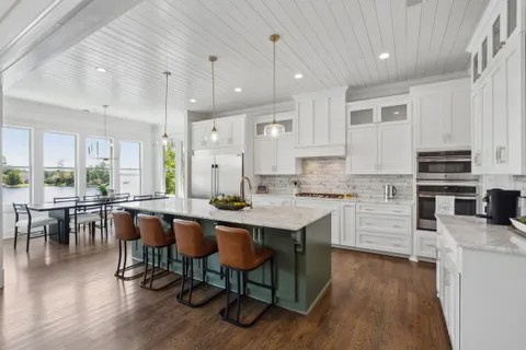 a dining room with furniture a chandelier and wooden floor