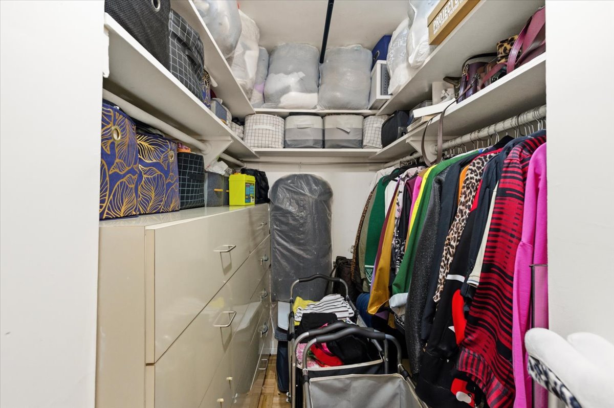 448 Neptune Avenue, Unit 14J Brooklyn, NY 11224 - Photo 12 of 21 a view of walk in closet with clothes and shoes