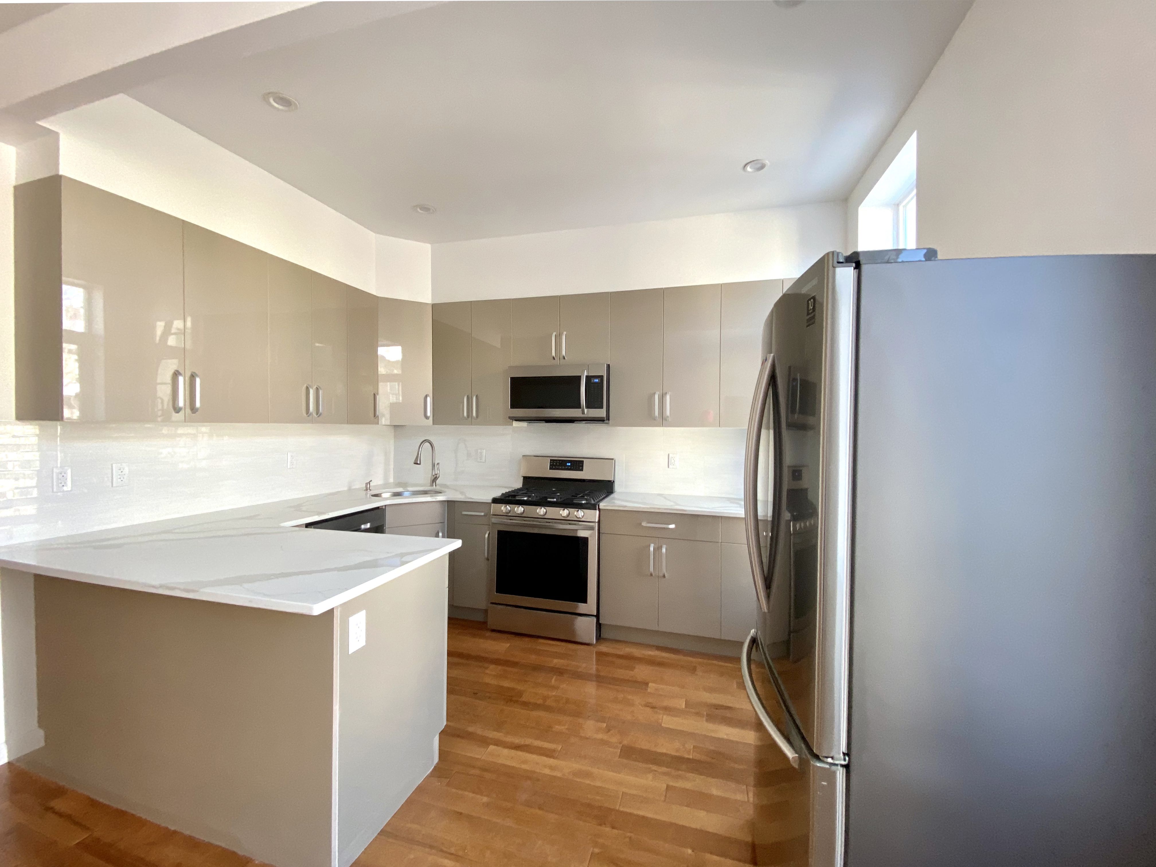 175 Luquer Street, Unit 3 Brooklyn, NY 11231 - Photo 2 of 12 a kitchen with stainless steel appliances granite countertop a refrigerator a stove top oven a sink and dishwasher