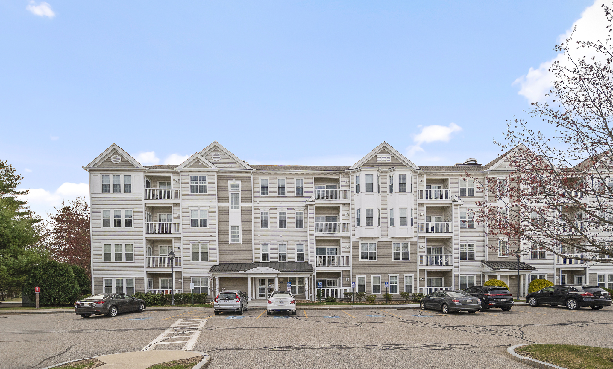 107 Clocktower Drive, Unit 407 Waltham, MA 02452 - Photo 17 of 19 a view of large building with a street