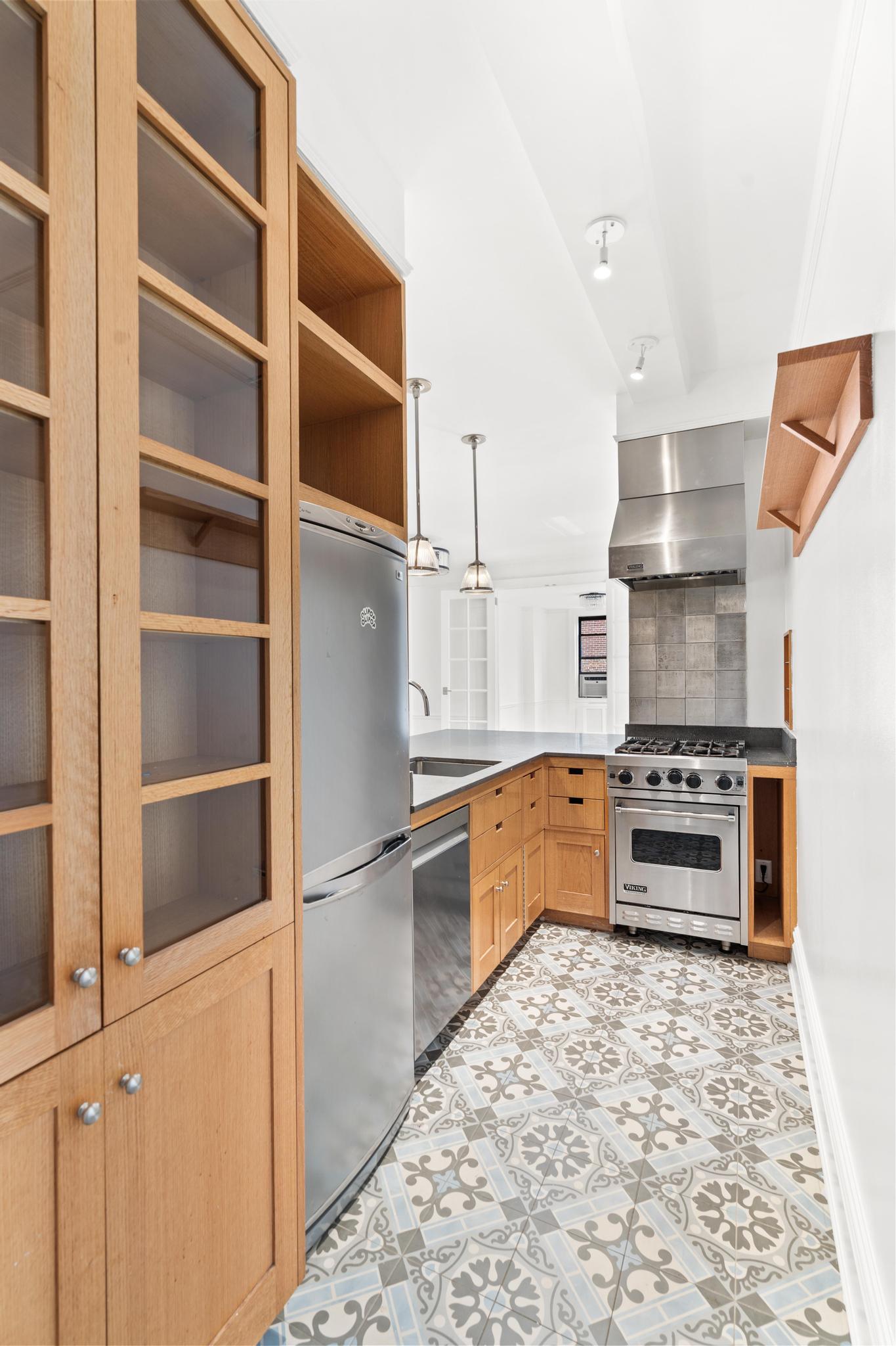885 West End Avenue, Unit 12D Manhattan, NY 10025 - Photo 9 of 24 a kitchen with stainless steel appliances a stove and a refrigerator