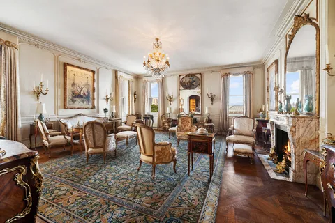 a living room with patio furniture and a large window