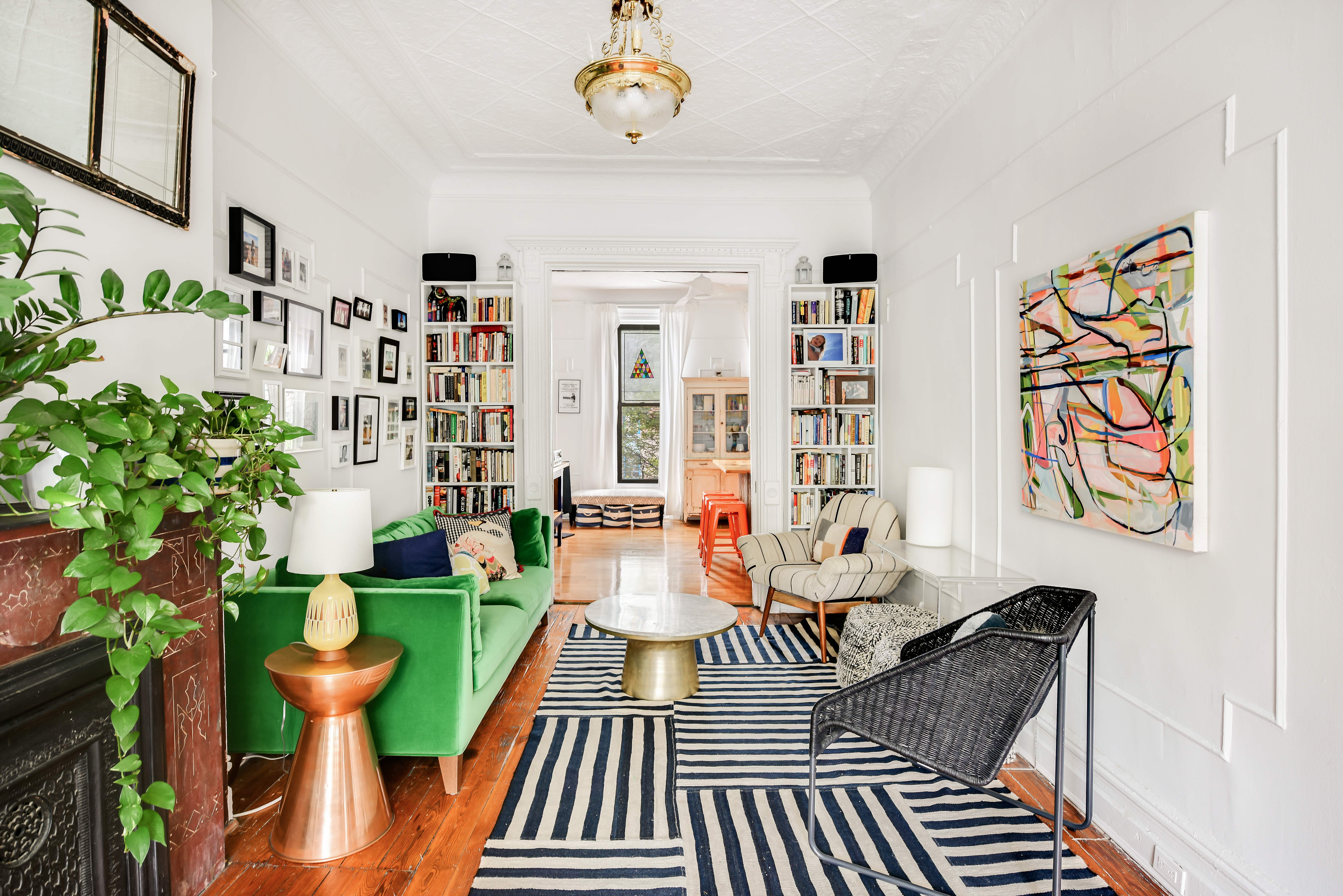 a living room with furniture and a potted plant