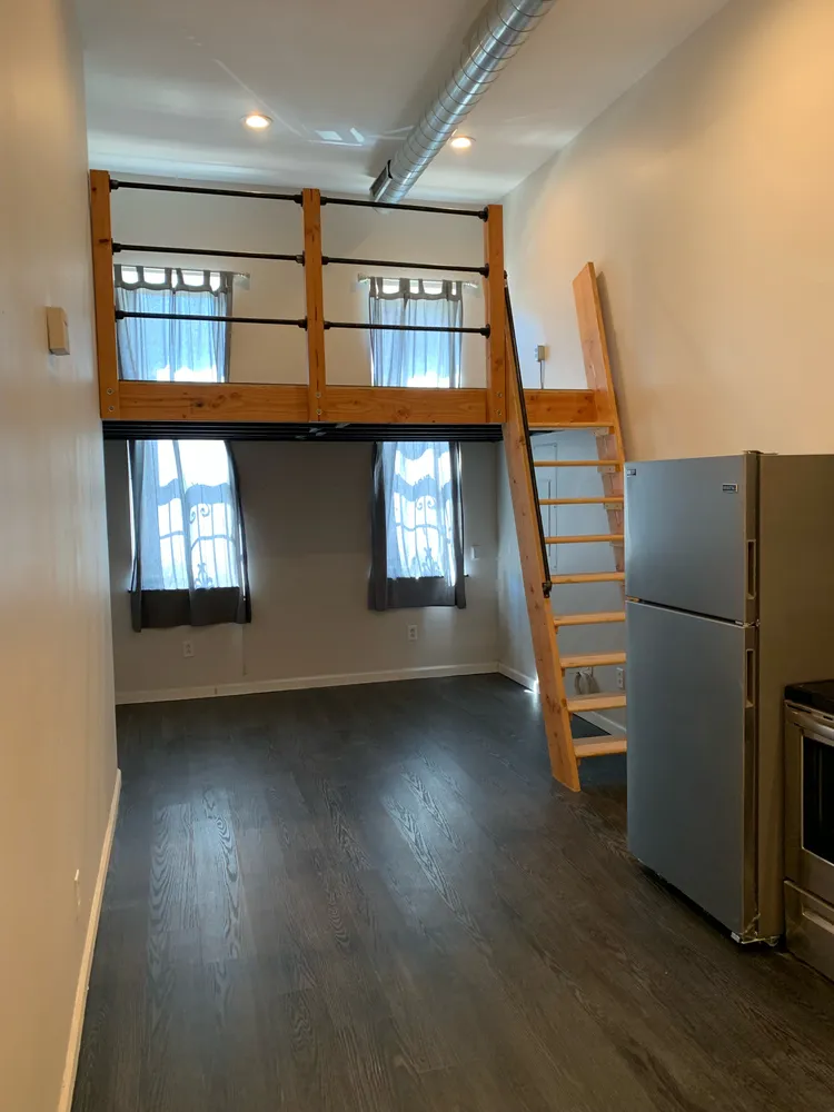 a view of a livingroom with furniture and wooden floor