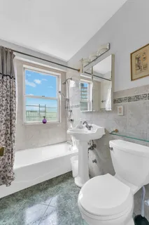 a bathroom with a toilet a sink and bathtub