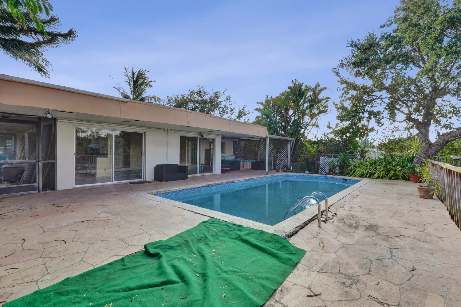 an aerial view of residential houses with outdoor space and trees all around