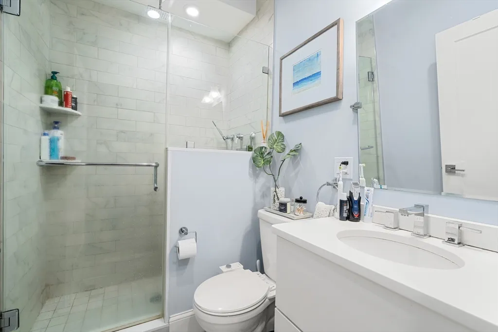 a bathroom with a sink toilet and shower